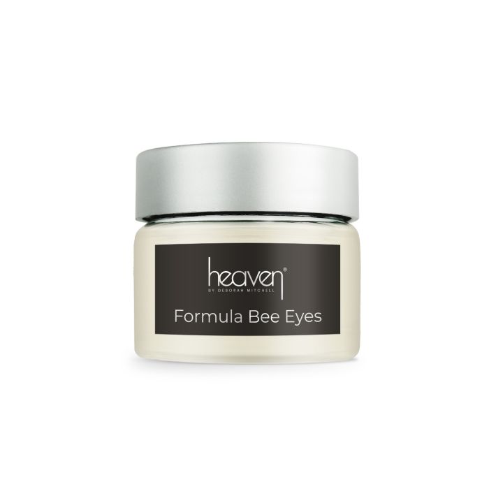 Image of Heaven's Formula Bee Eyes in a round, see-through container with a black label, white writing, a silver lid and cream coloured product inside.