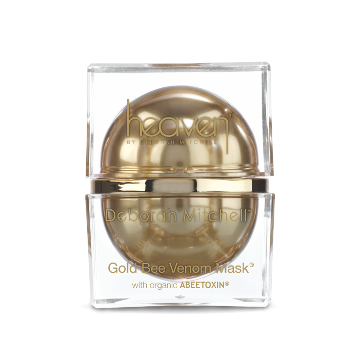 Photo of Heaven's Gold Bee Venom Mask from the front in a clear square container with a gold sphere in the middle of it and gold writing on the front that read Gold Bee Venom Mask with organic ABEETOXIN.